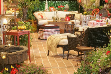 Inspiration for a mid-sized timeless backyard tile patio remodel in Orange County with a roof extension