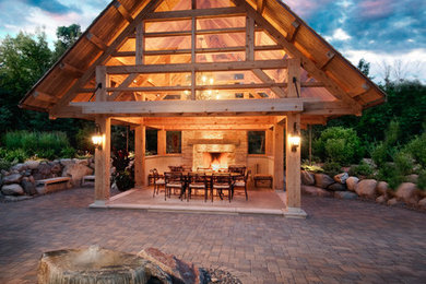 Example of a large transitional backyard concrete paver patio kitchen design in Minneapolis with a gazebo