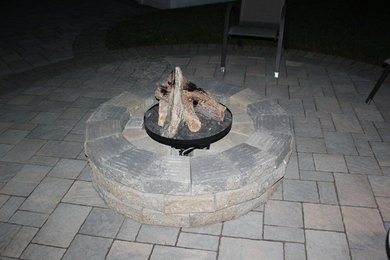 Mountain style backyard patio photo in Ottawa with a fire pit and no cover