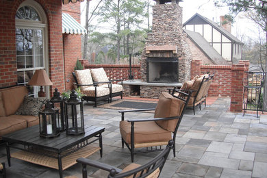 Large transitional backyard tile patio photo in Birmingham with a fire pit and an awning