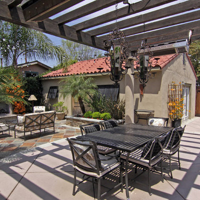 Tuscan patio photo in Orange County with a fire pit and a pergola