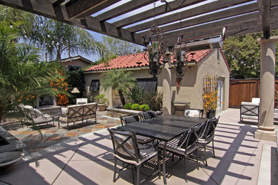 Inspiration for a mediterranean patio in Orange County with a fire feature and a pergola.