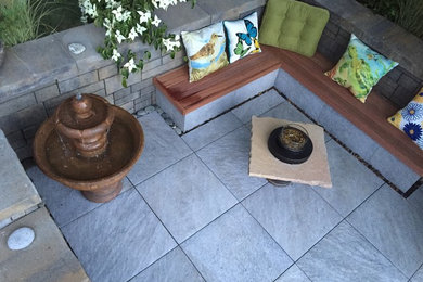 Patio - mid-sized contemporary backyard tile patio idea in Seattle with a roof extension