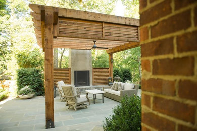 Example of a large classic backyard tile patio design in Birmingham with a fire pit and a pergola