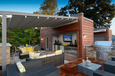 Inspiration for a large contemporary back patio in Other with an outdoor kitchen, decking and a pergola.