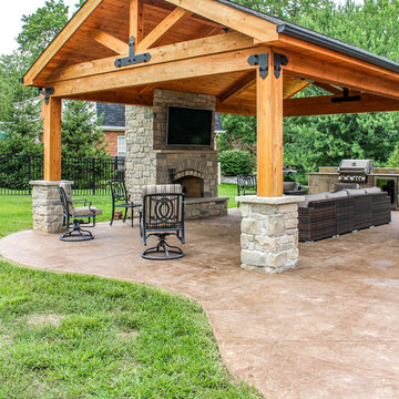 Outdoor Room with a Fireplace and Kitchen Feature