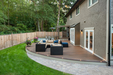 Inspiration for a huge modern backyard patio remodel in Vancouver with a fire pit, decking and no cover