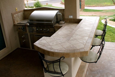 Inspiration for a mid-sized timeless backyard concrete patio kitchen remodel in Salt Lake City with a roof extension