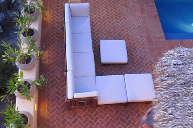 Large minimalist backyard brick patio photo in Atlanta with no cover