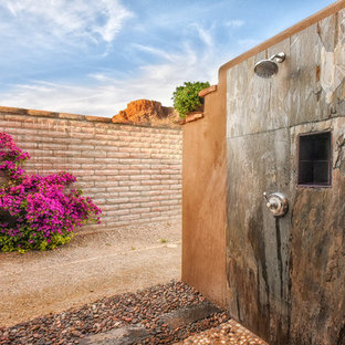 Outdoor patio shower - large contemporary backyard stone outdoor patio shower idea in Phoenix with a pergola
