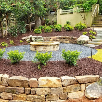 Example of a mid-sized classic backyard gravel patio design in Atlanta with a fire pit