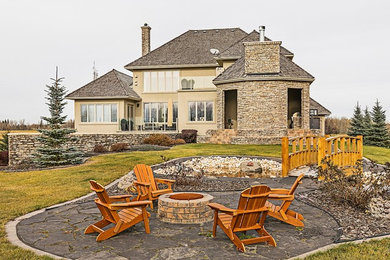 Inspiration for a mid-sized backyard stone patio remodel in Edmonton