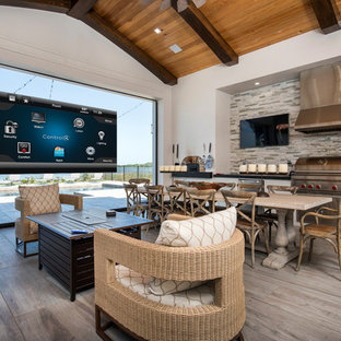 Inspiration for a transitional backyard patio kitchen remodel in Orlando with a roof extension
