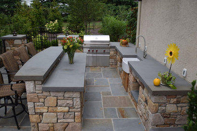 Example of a mid-sized arts and crafts backyard concrete paver patio kitchen design in Philadelphia with no cover