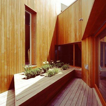 Outdoor terrace with walls clad in natural cedar.