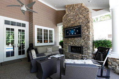 Inspiration for a mid-sized timeless backyard patio remodel in Minneapolis with a fire pit and a roof extension