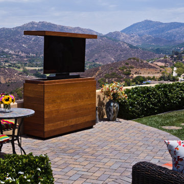 Outdoor TV lift island cabinet hides TV and keeps it safe