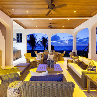 Esempio di un grande patio o portico dietro casa con un caminetto, piastrelle e un gazebo o capanno
