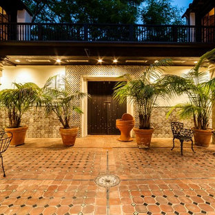 Photo of a large mediterranean courtyard patio in Los Angeles with tile and no cover.