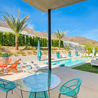 Patio - 1950s backyard concrete patio idea in Orange County with a roof extension
