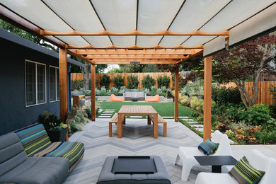 Patio - mid-sized contemporary backyard concrete paver patio idea in San Francisco with a pergola