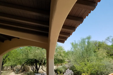 Example of a mid-sized southwest backyard patio design in Phoenix with a roof extension