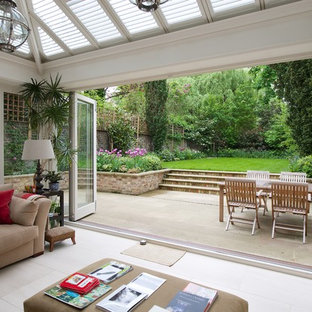 This is an example of a mid-sized contemporary backyard patio in London with no cover.