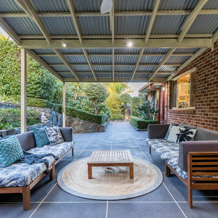 This is an example of a large transitional patio in Other with concrete slab and a pergola.
