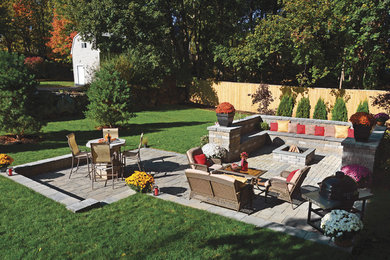 Inspiration for a classic back patio in Boston with brick paving and no cover.
