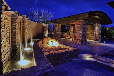 Inspiration for a large modern back patio in Houston with a fire feature, concrete slabs and a roof extension.