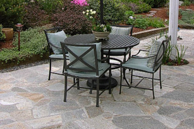 Patio - mid-sized traditional backyard stone patio idea in Seattle