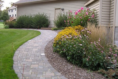 Mid-sized elegant side yard brick patio photo in Minneapolis with no cover