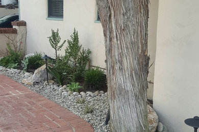 Mid-sized tuscan side yard brick patio photo in San Diego with no cover