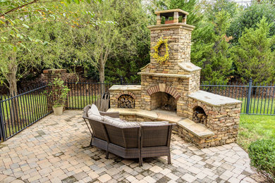 Small arts and crafts side yard concrete paver patio photo in Other with a fire pit