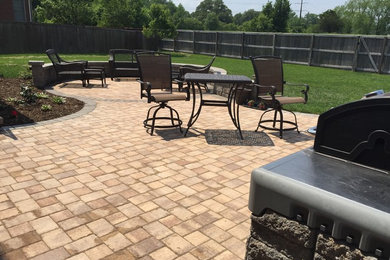 Inspiration for a large timeless backyard concrete paver patio kitchen remodel in Other