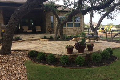 Patio and landscaping with new construction