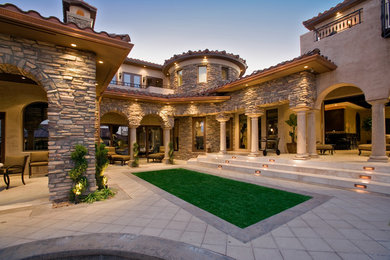 Expansive mediterranean back patio in Las Vegas with an outdoor kitchen.