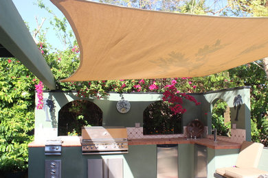 Example of a trendy backyard patio kitchen design in Other with a roof extension