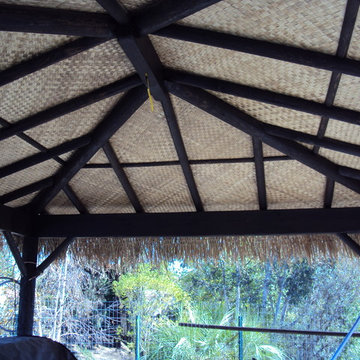 Patio Covers | lodge pole tiki hut with banana and thatch roof