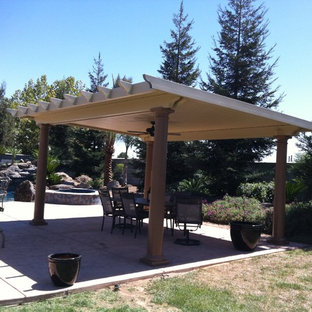 Inspiration for a mid-sized timeless backyard concrete patio kitchen remodel in Other with a gazebo