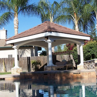 Inspiration for a mid-sized mediterranean backyard concrete patio fountain remodel in Other with a gazebo