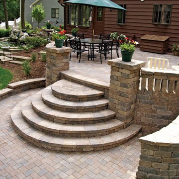 Patio featuring pillars and steps using Unilock Olde Quarry paver