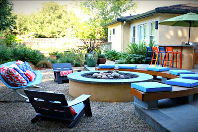 Example of a mid-sized minimalist backyard tile patio design in Austin with a fire pit and no cover