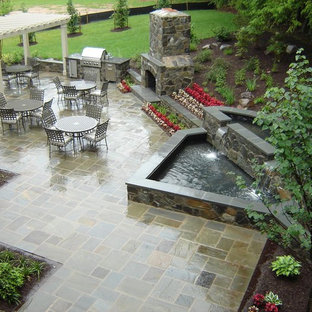 Example of a classic patio design in Baltimore with a fire pit and a gazebo