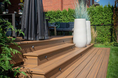 Trendy backyard patio photo in Montreal with decking and a pergola