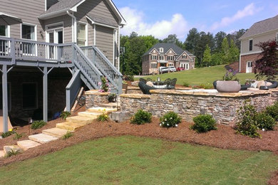 Example of a large classic backyard stone patio design in Atlanta with no cover