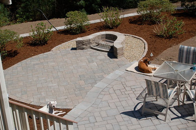 Classic back patio in Providence with concrete paving.