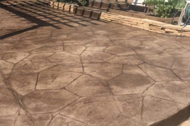 Inspiration for a small classic back patio in Denver with stamped concrete and no cover.