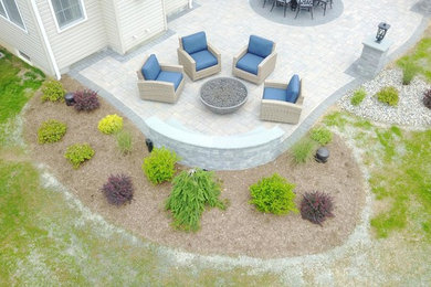 Inspiration for a large timeless backyard concrete paver patio remodel in New York
