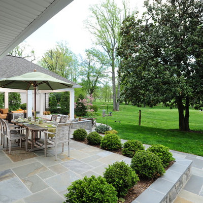 Mid-sized elegant backyard stone patio photo in DC Metro